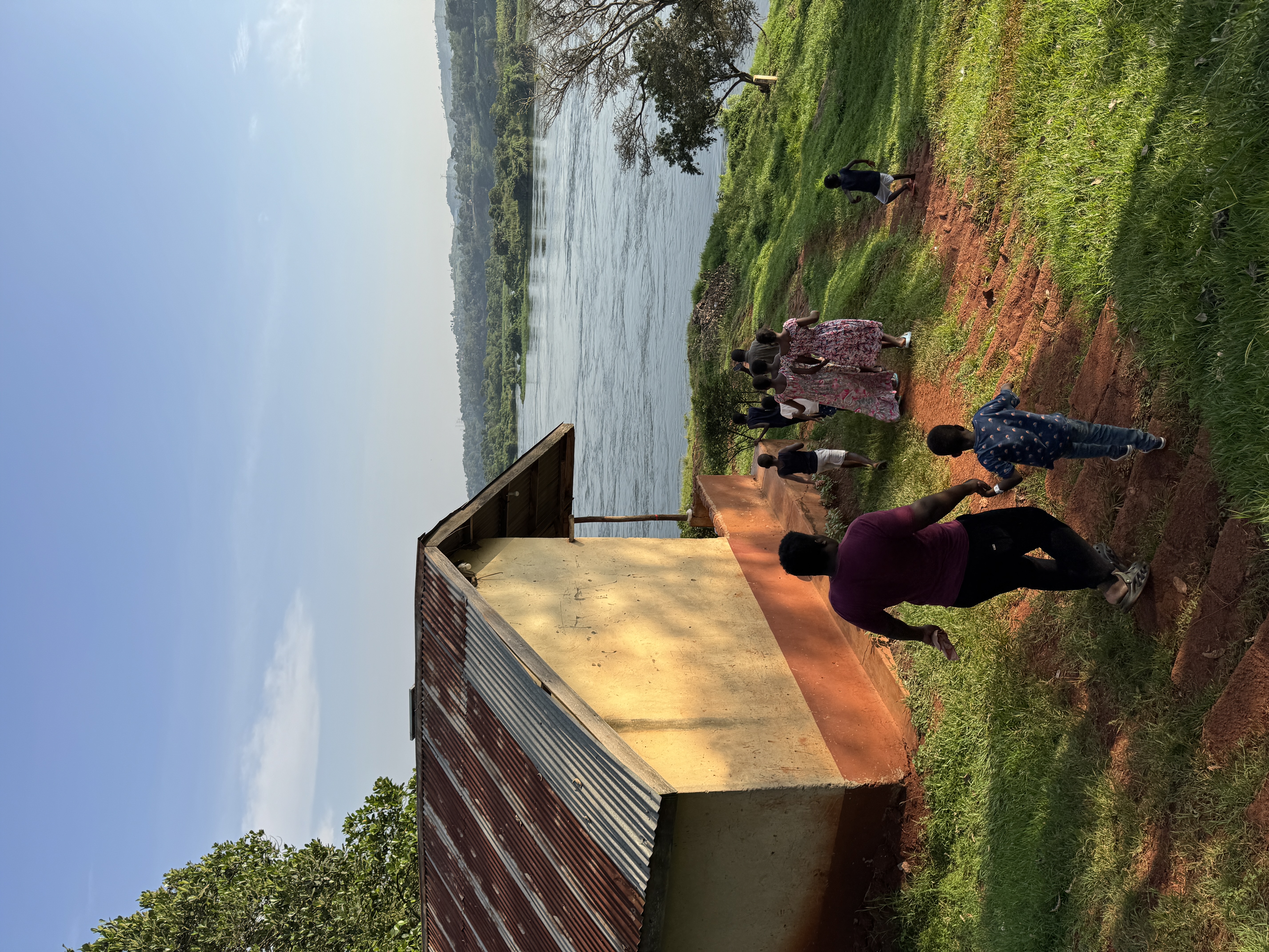 The children and carers walking together toward the river near their home